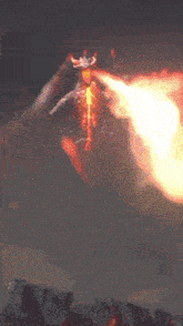 a fireball is being thrown from a person 's hand in the dark