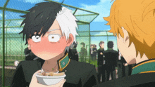 a boy with black hair and white hair is holding a bowl of food in front of his face