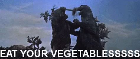 gif of Kong putting trees in Godzilla's mouth
