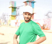 a man in a green shirt and white hat is smiling