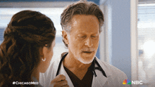 a doctor talking to a nurse with #chicagomed written on the bottom
