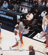 a basketball game is being played in front of a banner that says more at com / podcasts