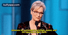 a woman speaking into a microphone with the words someone he outranked in privilege power and the capacity to fight back .
