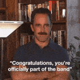 a man with a mustache says " congratulations you 're officially part of the band " while standing