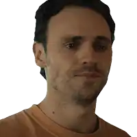 a man with a beard wearing an orange shirt