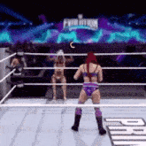 a woman is standing in a wrestling ring with a sign that says evolution in the background .