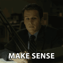 a man in a suit and tie sits at a desk with the words make sense written below him