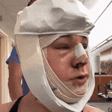 a person with a bandage on their head has a bandage on the nose
