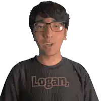 a man wearing glasses and a black shirt that says logan on it