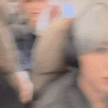a blurry picture of a person 's face with a gray background