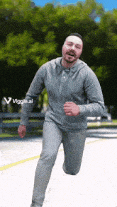 a man in a grey hoodie is running down a street with a viggle.ai logo in the background