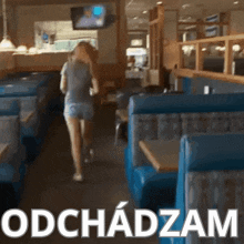 a blurred image of a woman walking in a diner with the words obchodzam written below her