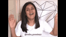 a girl with braces on her teeth is wearing a white shirt with the name maibe_gonzalezt on it