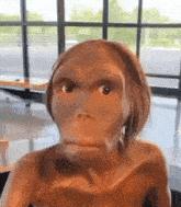a close up of a statue of a human looking at the camera with a window in the background