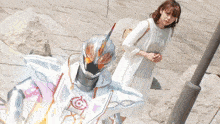 a woman in a white dress stands next to a robot with a helmet that says infinity