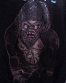 a drawing of a gorilla with red eyes is on a black shirt