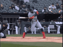 a baseball player swings his bat at a pitch in front of a banner that says hsn