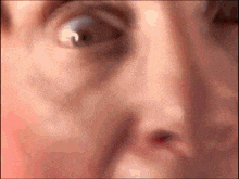 a close up of a man 's face with a blurred background