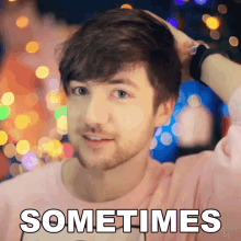 a man with a beard is wearing a pink shirt with the word sometimes on it