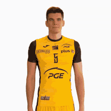 a man wearing a yellow and black pge plus shirt
