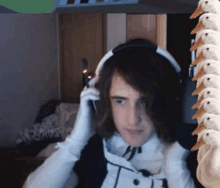 a young man wearing headphones and white gloves