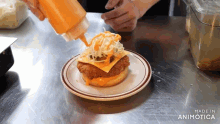 a chicken sandwich with cheese and onions on a plate that says made in animotica