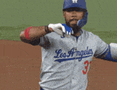 a baseball player wearing a los angeles jersey with the number 37 on it