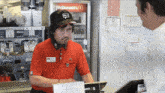 a man talking to another man in front of a mcdonald 's sign