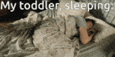a woman is sleeping on a bed with the words my toddler sleeping below her