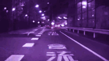 a blurry picture of a street with a purple background and the letter l