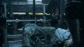 a man is lifting a barbell on a bench in a dark gym