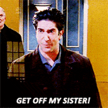 a man is standing in front of a door and says get off my sister !