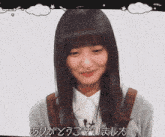 a girl is smiling in front of a white background with chinese writing on it