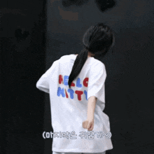 a woman wearing a white hello kitty shirt