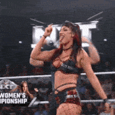 a woman in a wrestling ring with the words women 's championship on the bottom