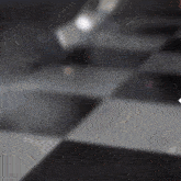 a checkered floor with a white arrow pointing to the right