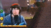 a man wearing headphones is talking into a microphone .