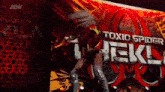 a woman stands in front of a sign that says toxic spider tekl