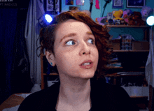a woman with red hair looks up at something in front of a sign that says sub x44