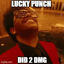 a man wearing sunglasses and a red suit is smiling and says lucky punch did 2 dmg
