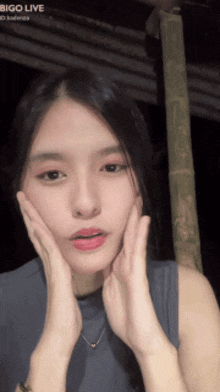 a girl with bigo live written on the bottom of her face