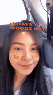 a woman is sitting in a car with the words have a woodz day above her head