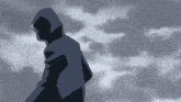 a person in a hoodie stands in front of a cloudy sky