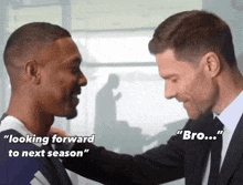 a man in a suit talks to another man with the words " looking forward to next season "