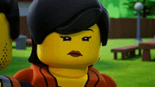 a close up of a yellow lego figure with black hair