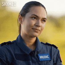 a woman in a skymed uniform has a patch on her chest that says medic