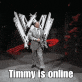 a man in a suit and tie is dancing in front of a wrestling logo and the words timmy is online