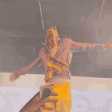 a person is taking a picture of a man walking on stage
