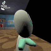 a cartoon character with green arms and legs is standing in a room with a brick wall in the background .