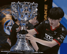 a man holding a trophy that says fog on it